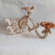 Wall lamp in antique cast iron with bird and scroll decorations.