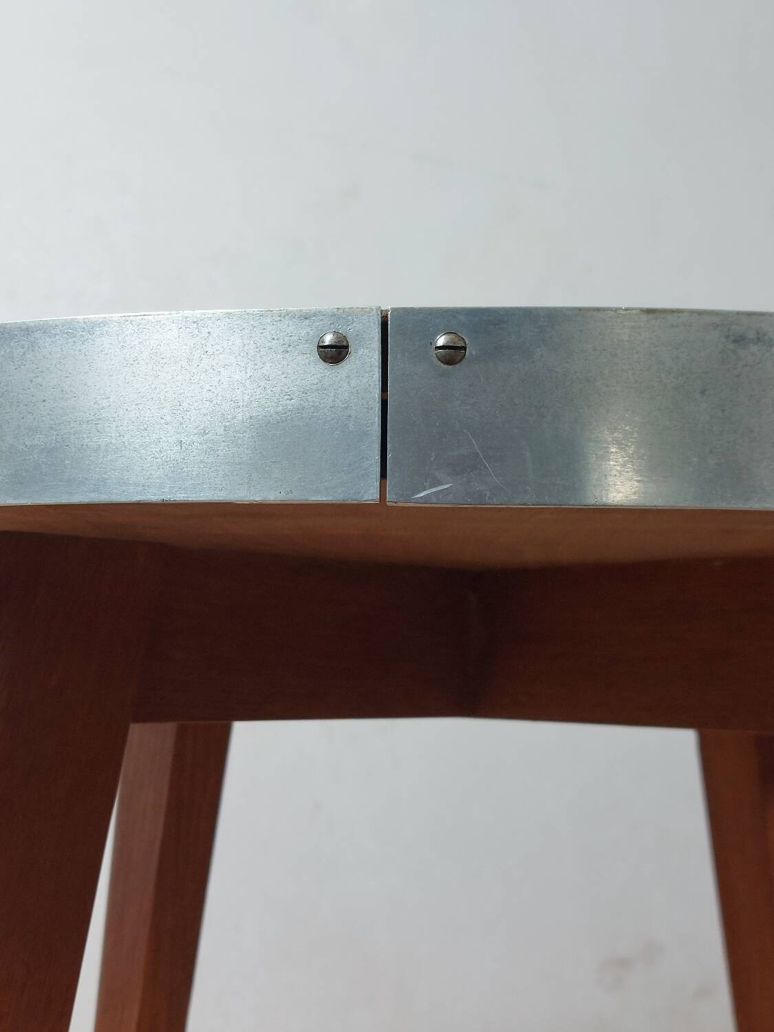 Vintage metal and teak side table from the 1950s.
