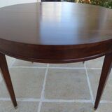 Round mahogany table with mahogany veneer and brass sabot foot.