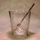 Vintage crystal ice bucket with gold tongs.