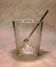 Vintage crystal ice bucket with gold tongs.