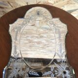 Old beveled Venetian mirror with engraved flower decoration
