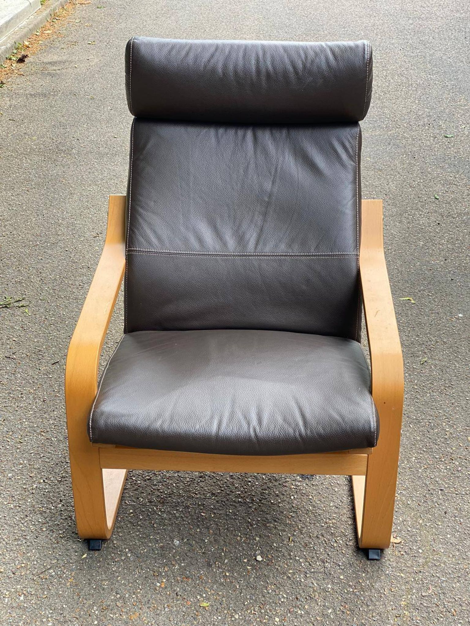 Scandinavian rocking chair in curved wood and brown leather from IKEA Poang
