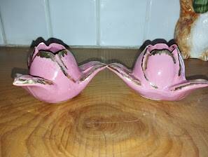 A pair of pink earthenware candlesticks (1940s–50s)