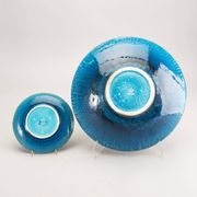 A stoneware bowl and 11 plates by Charlotte Hamilton, Sweden, 1970, Signed