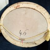 Golden oval art deco mirror