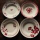 A set of 4 mismatched Art Deco red blue soup plates