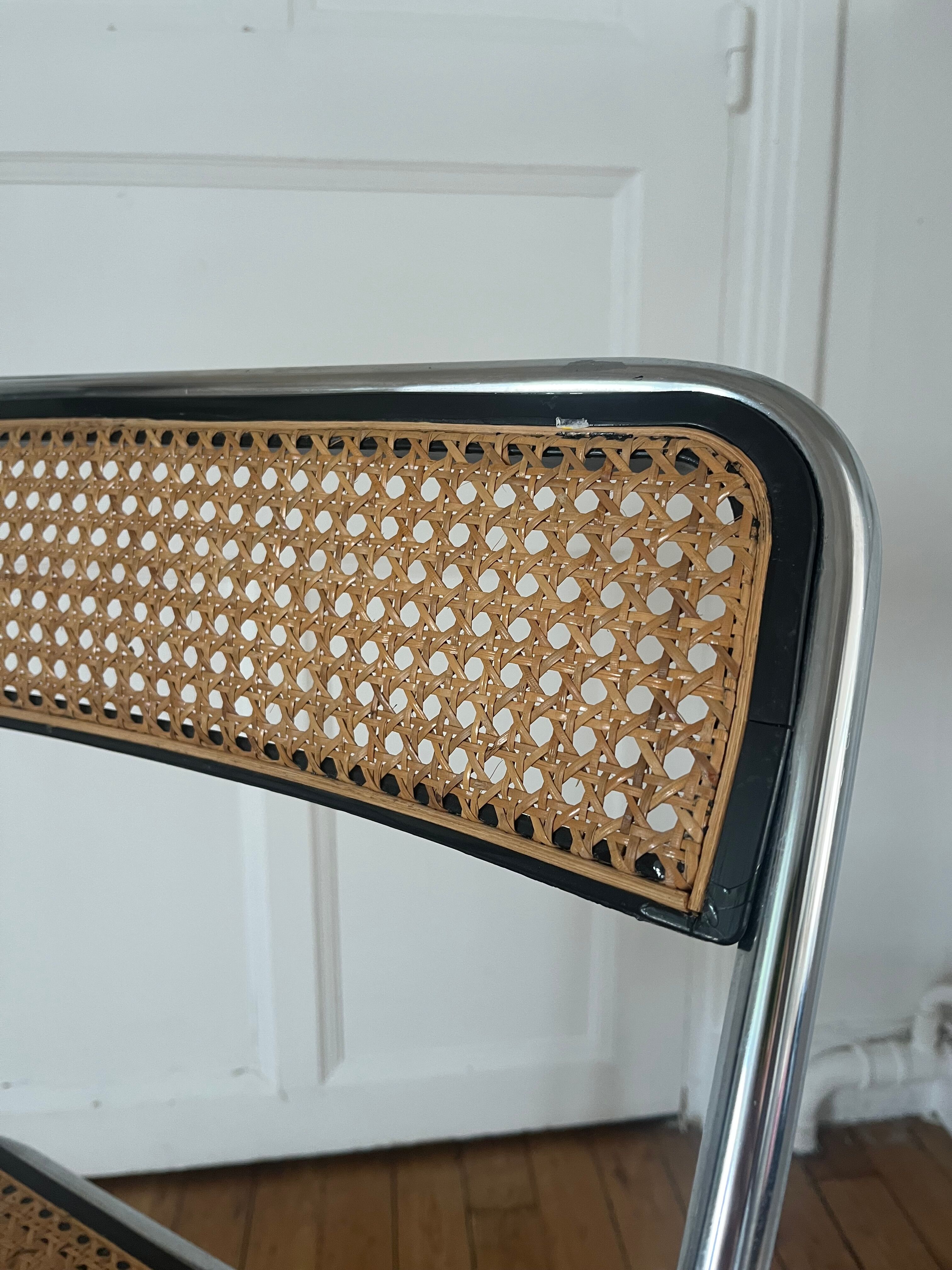 Vintage folding chair in metal and cane.