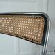 Vintage folding chair in metal and cane.