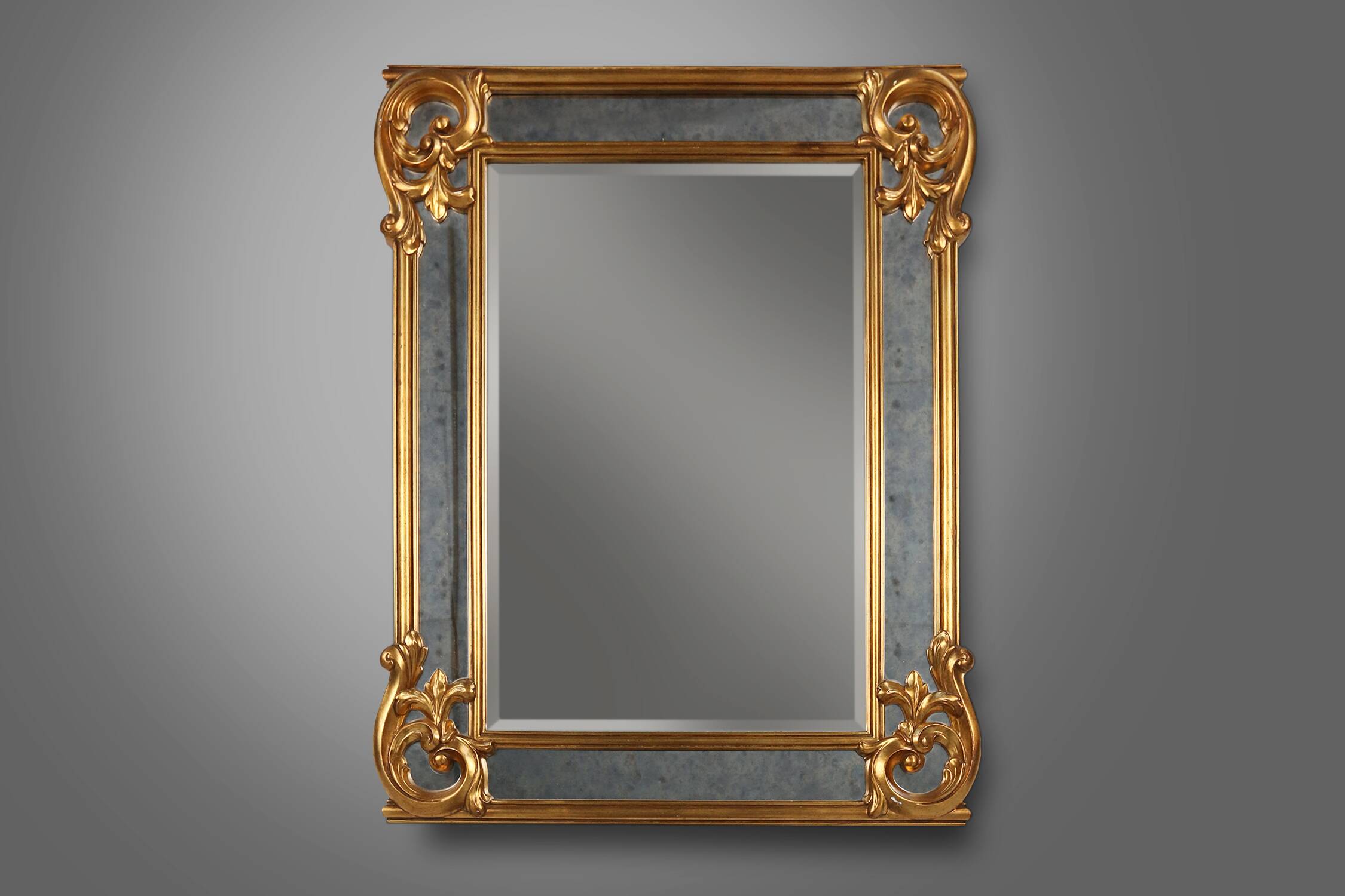 Richly decorated wall mirror in resin with golden ornaments and smoked mirror glass panels, Belgium,