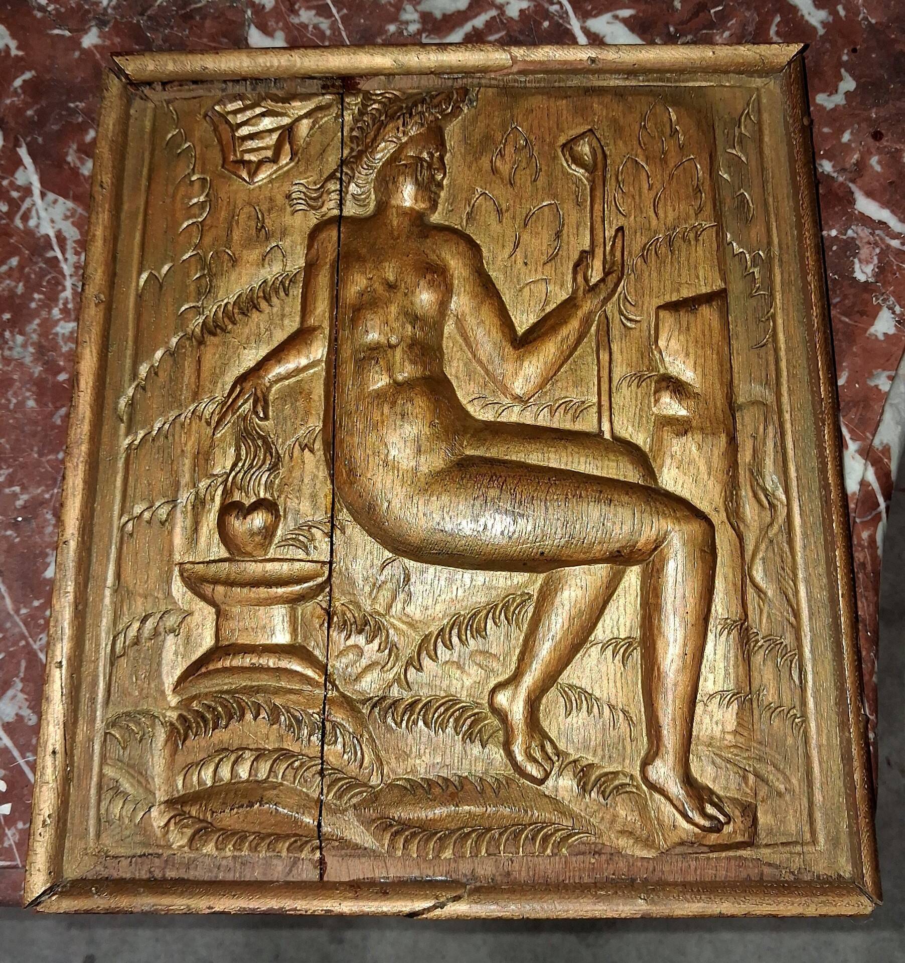 Carved oak panel depicting an allegorical female figure.