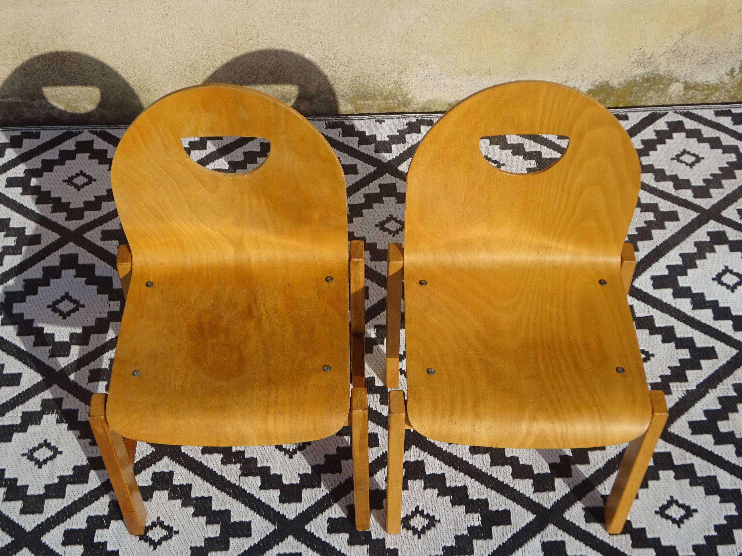 Pair of light wood chairs with post-formed seat and backrest.