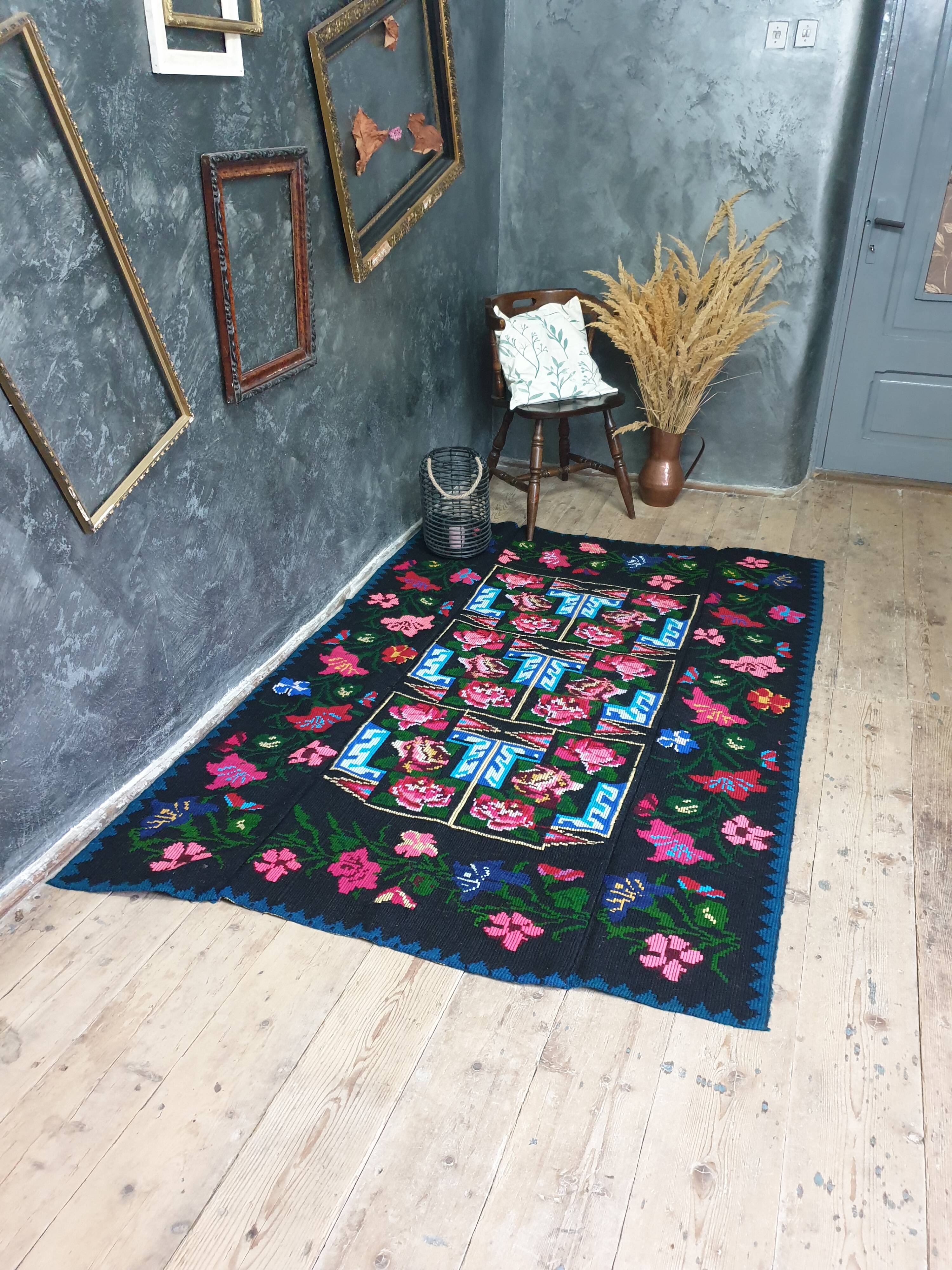 Handwoven floral wool rug, black background with pink roses and geometric design 207x144cm
