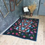 Handwoven floral wool rug, black background with pink roses and geometric design 207x144cm