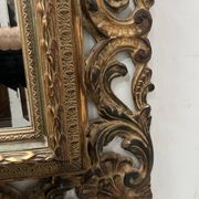 Napoleon III style mirror in carved wood, 20th century.