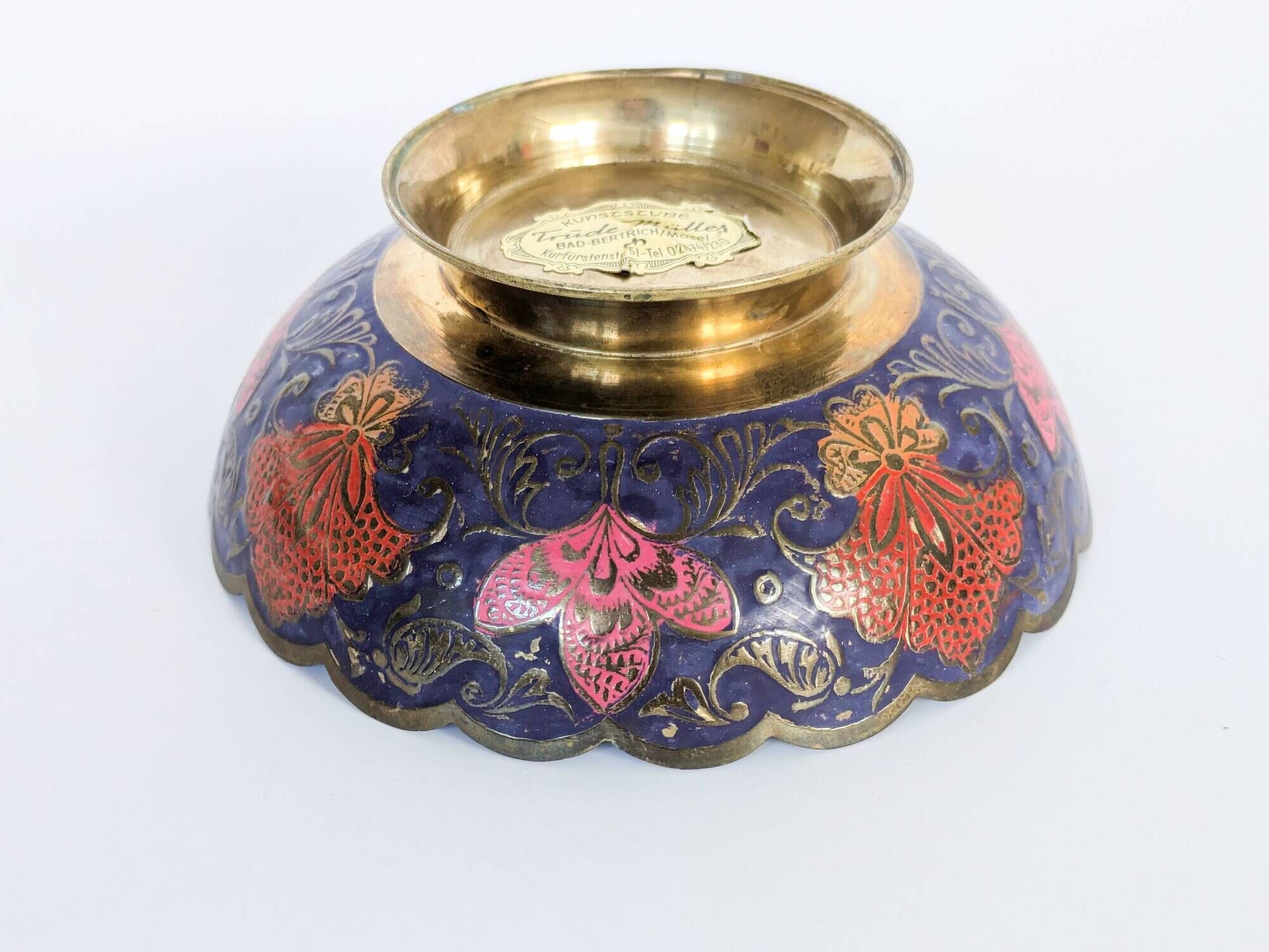 Vintage brass bowl with peacock motif, painted enamel, scalloped edge on a pedestal.