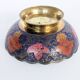 Vintage brass bowl with peacock motif, painted enamel, scalloped edge on a pedestal.