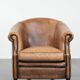 Club chair made of sheepskin leather finished with decorative nails