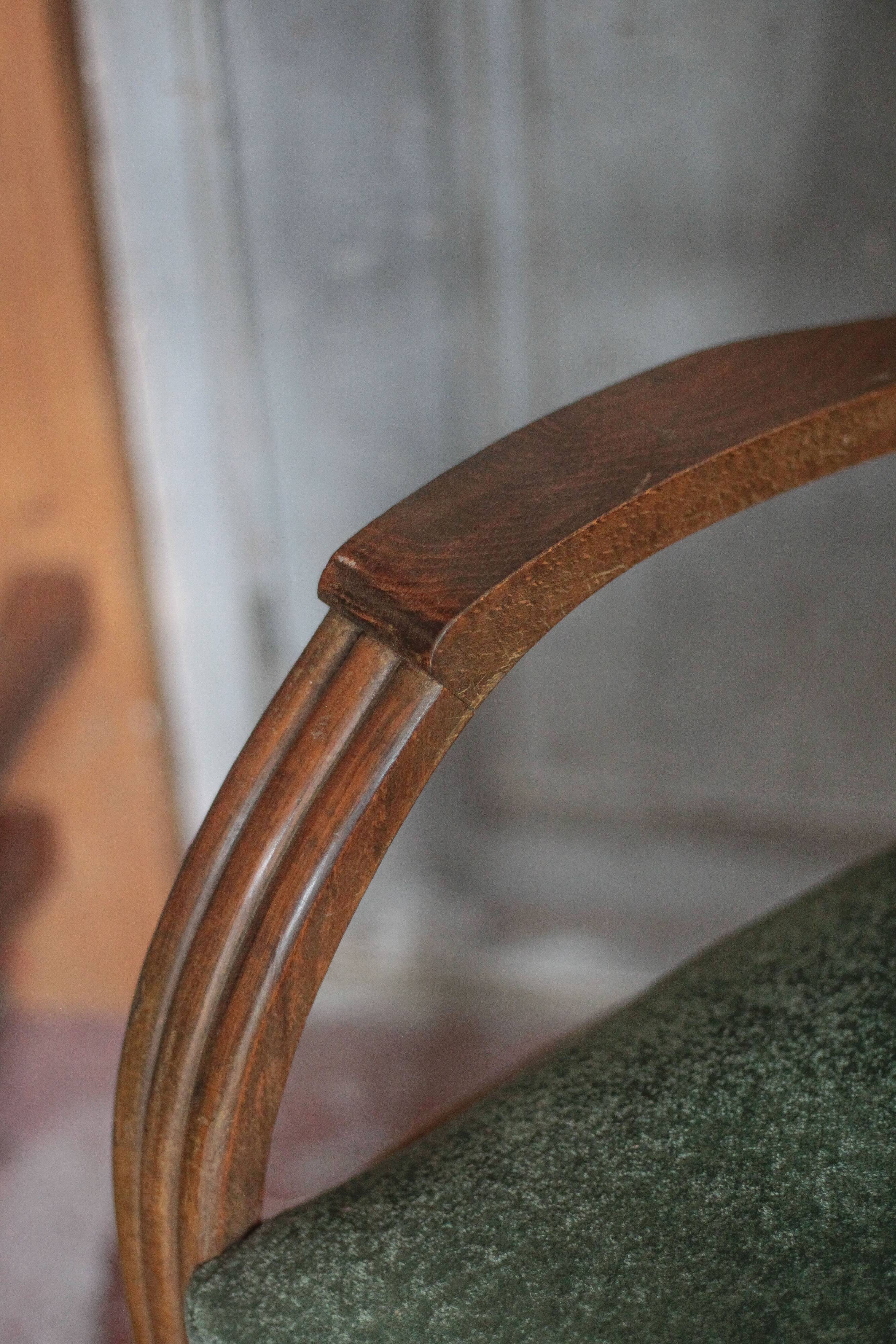 Art Deco armchair in wood and green fabric, living room armchair, interior decor.