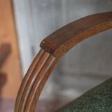 Art Deco armchair in wood and green fabric, living room armchair, interior decor.