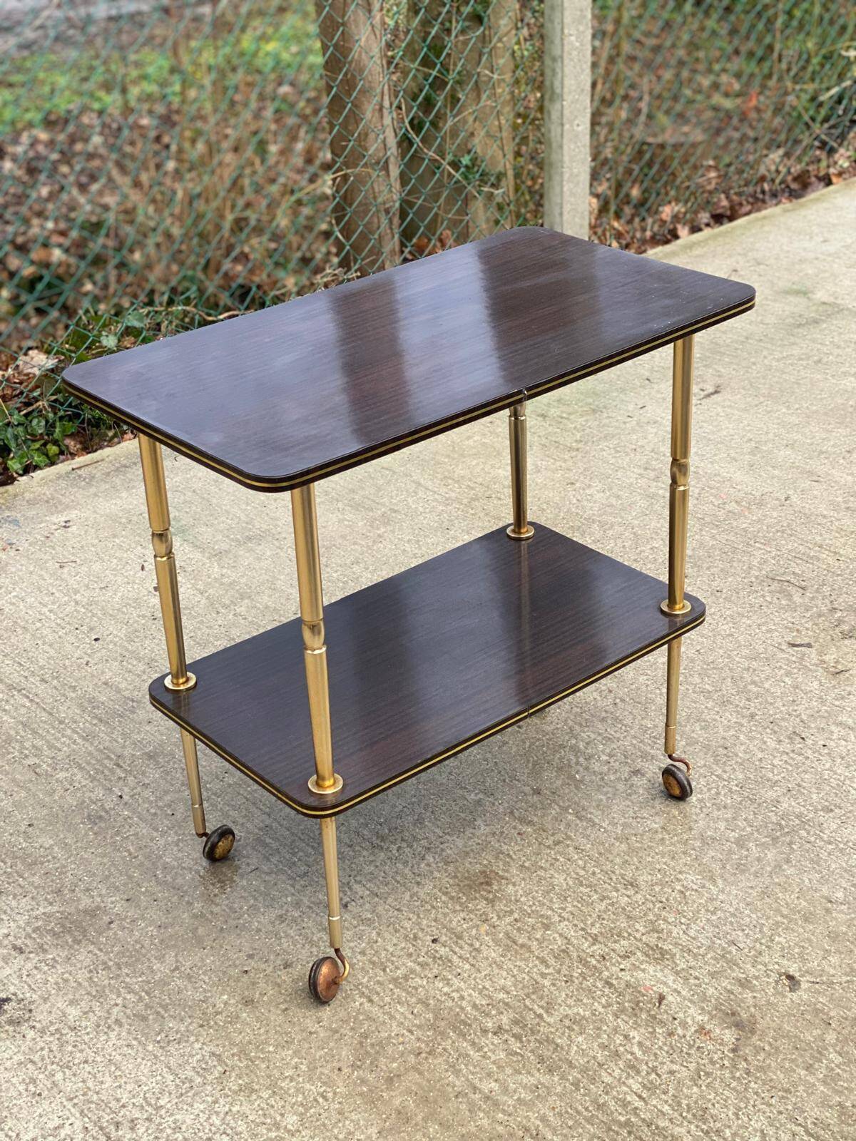 Brown rosewood rolling table with gold legs