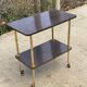 Brown rosewood rolling table with gold legs