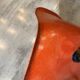 A vintage 70s Eames Herman Miller DSW Fiber Red Orange Dowel Walnut Chair
