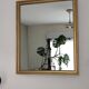 Antique mirror with a gilded frame and beaded border.
