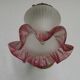 French Art Nouveau wall sconce in bronze with a white and pink glass shade.