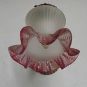 French Art Nouveau wall sconce in bronze with a white and pink glass shade.