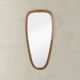 Wonderful 1950s mirror on a teak wood panel with brass frame. Made in Germany