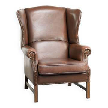 Cowhide wingback armchair in English style finished with decorative nails