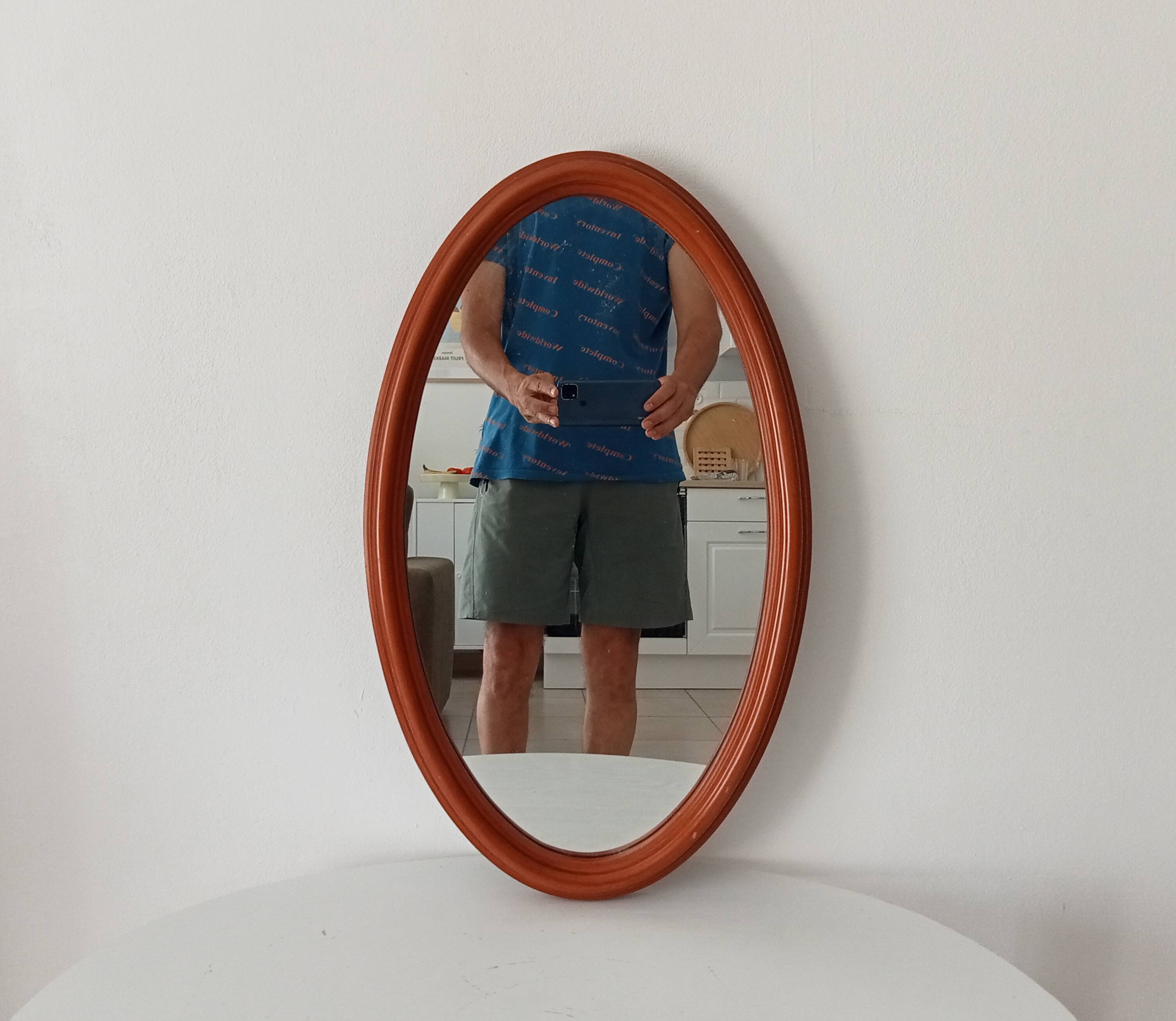 Vintage oval wooden mirror "caramel" from the 1960s.