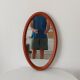 Vintage oval wooden mirror "caramel" from the 1960s.
