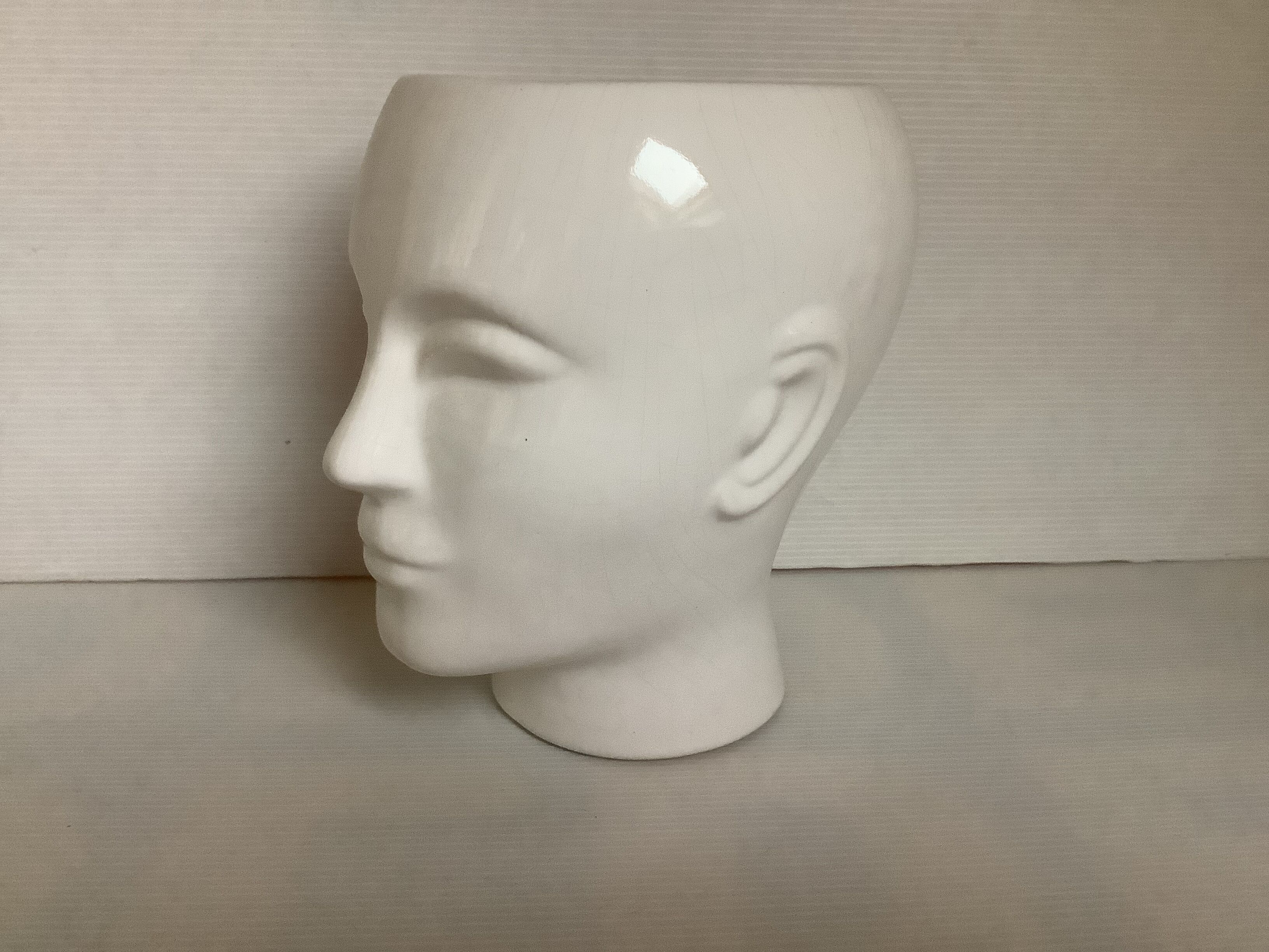 Man's head hide pot vase