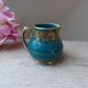 Old small Sadler cream pot in blue-green ceramic with a gold pattern, English milk jug.