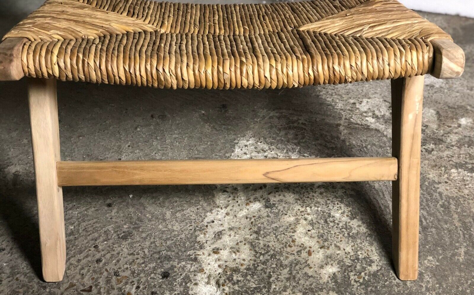 Low armchair in raw teak with seat and mulched backrest
