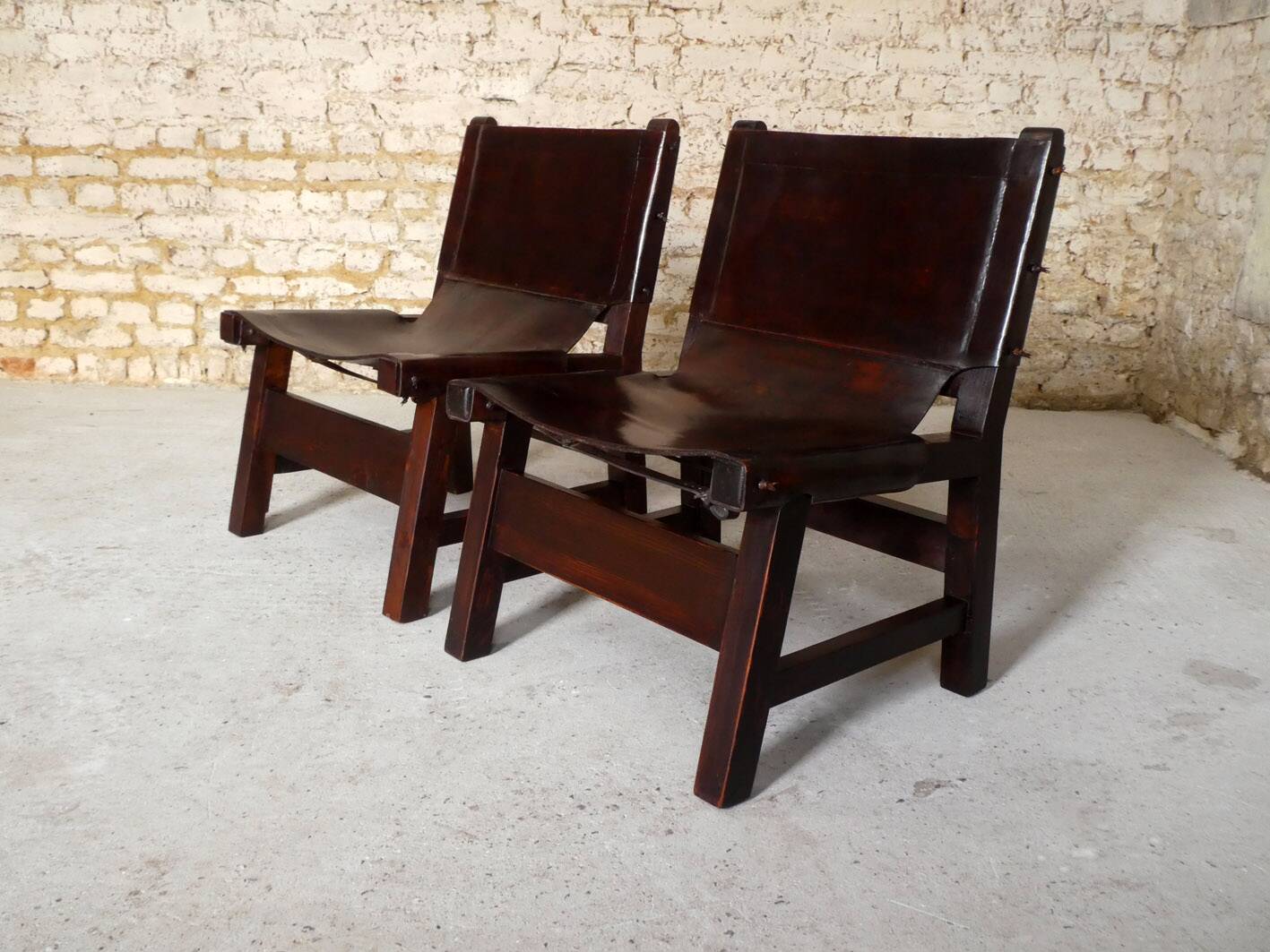 Pair of brutalist armchairs in wood and leather, 1970