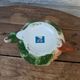 Ceramic teapot in the shape of a rose with a butterfly and raised petals.