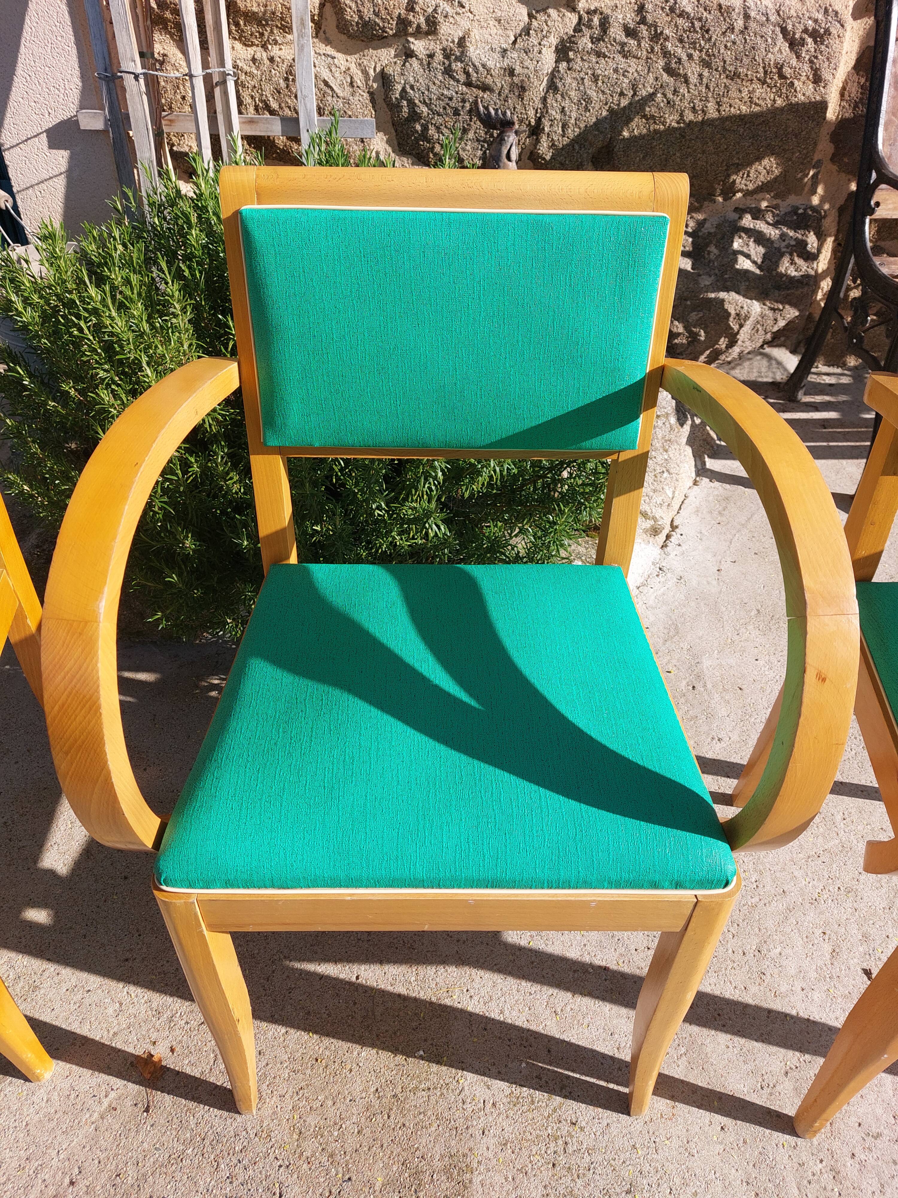 3 vintage bridge chairs with rounded armrests.
