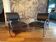 Pair of chrome and faux leather armchairs