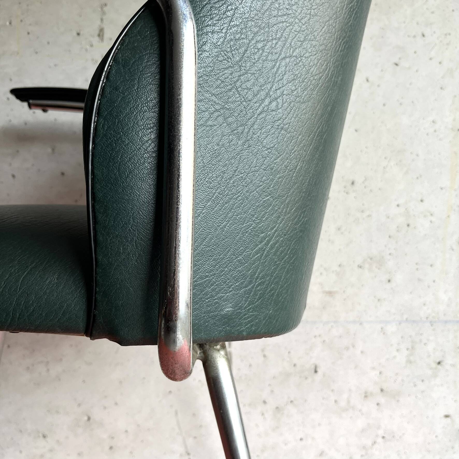 Vintage green faux leather and chrome armchair