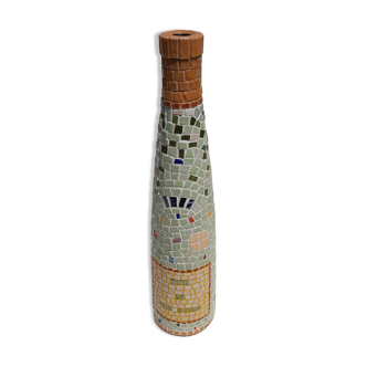 Decorative glass wine bottle covered with ceramic mosaic