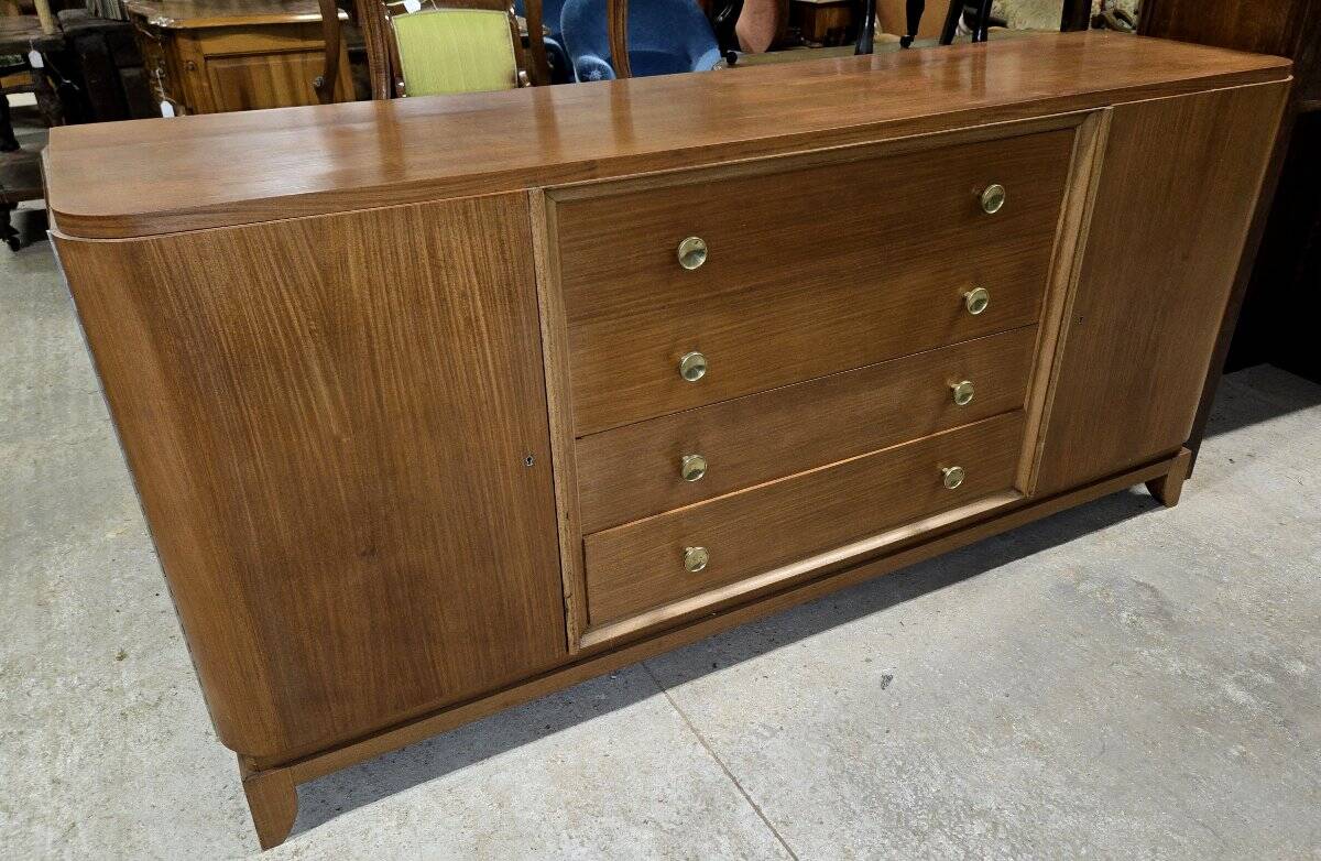 According to André Arbus, a sideboard in a row from the Art Deco period in blonde mahogany.