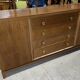 According to André Arbus, a sideboard in a row from the Art Deco period in blonde mahogany.