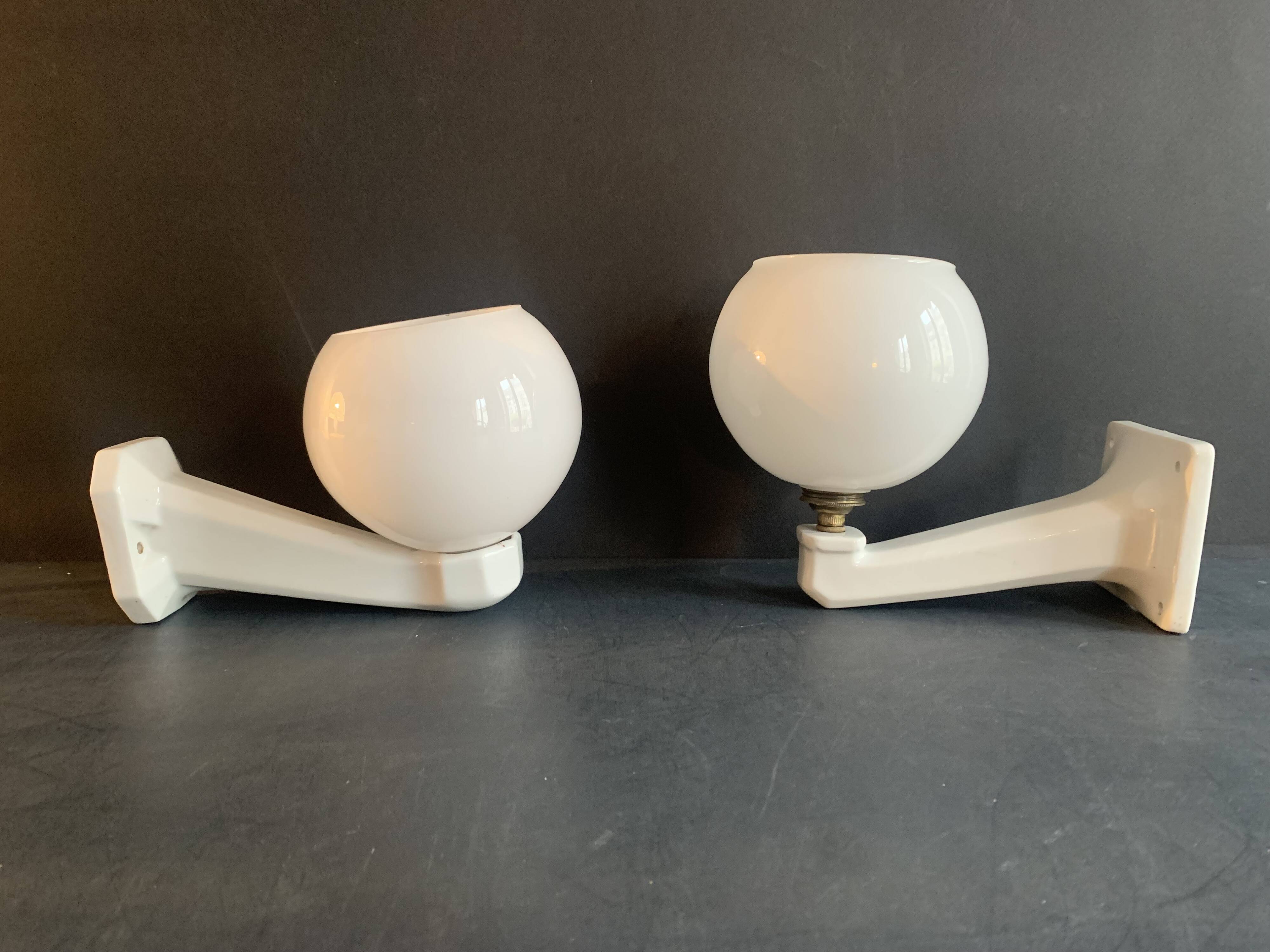 Pair of Art Deco porcelain wall lights with white Opaline globes, 1920
