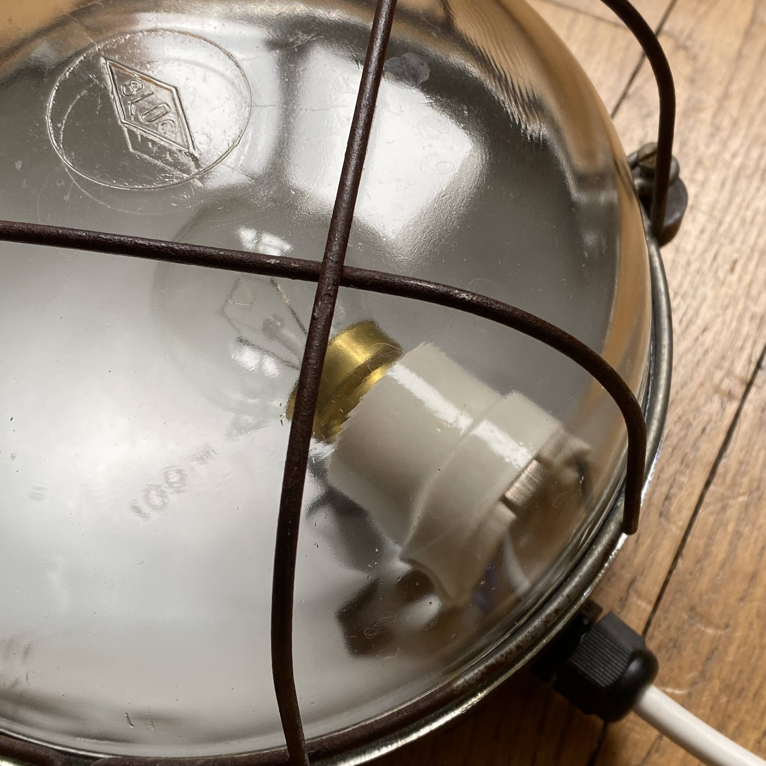 Waterproof industrial porthole light in Bakelite with a glass globe.
