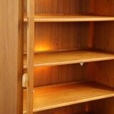 Elegant vintage Danish display cabinet with glass panels and atmospheric lighting