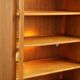 Elegant vintage Danish display cabinet with glass panels and atmospheric lighting