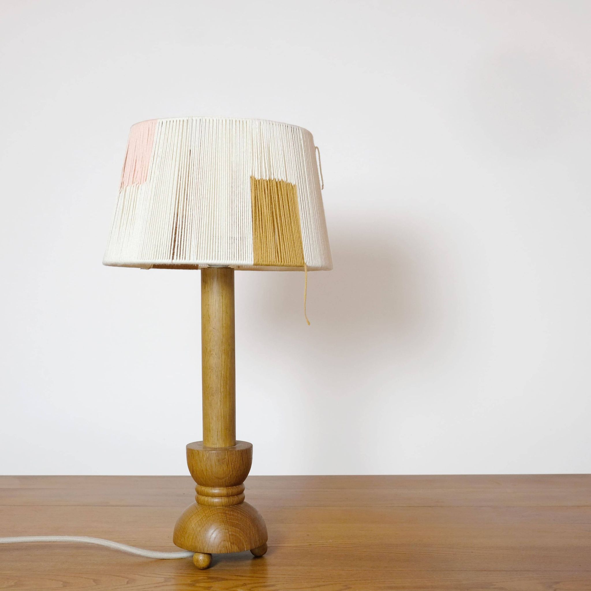Wooden candle holder mounted as a lamp and its rope shade, 47.5cm.